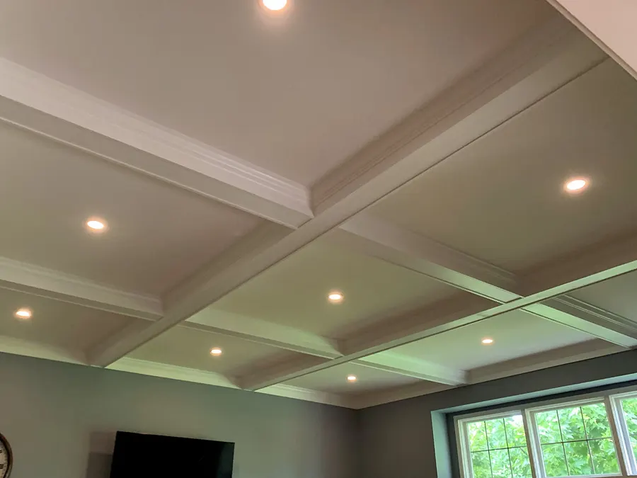 White coffered ceiling with crown-molded beams and recessed lighting in a finished living space, Naperville IL