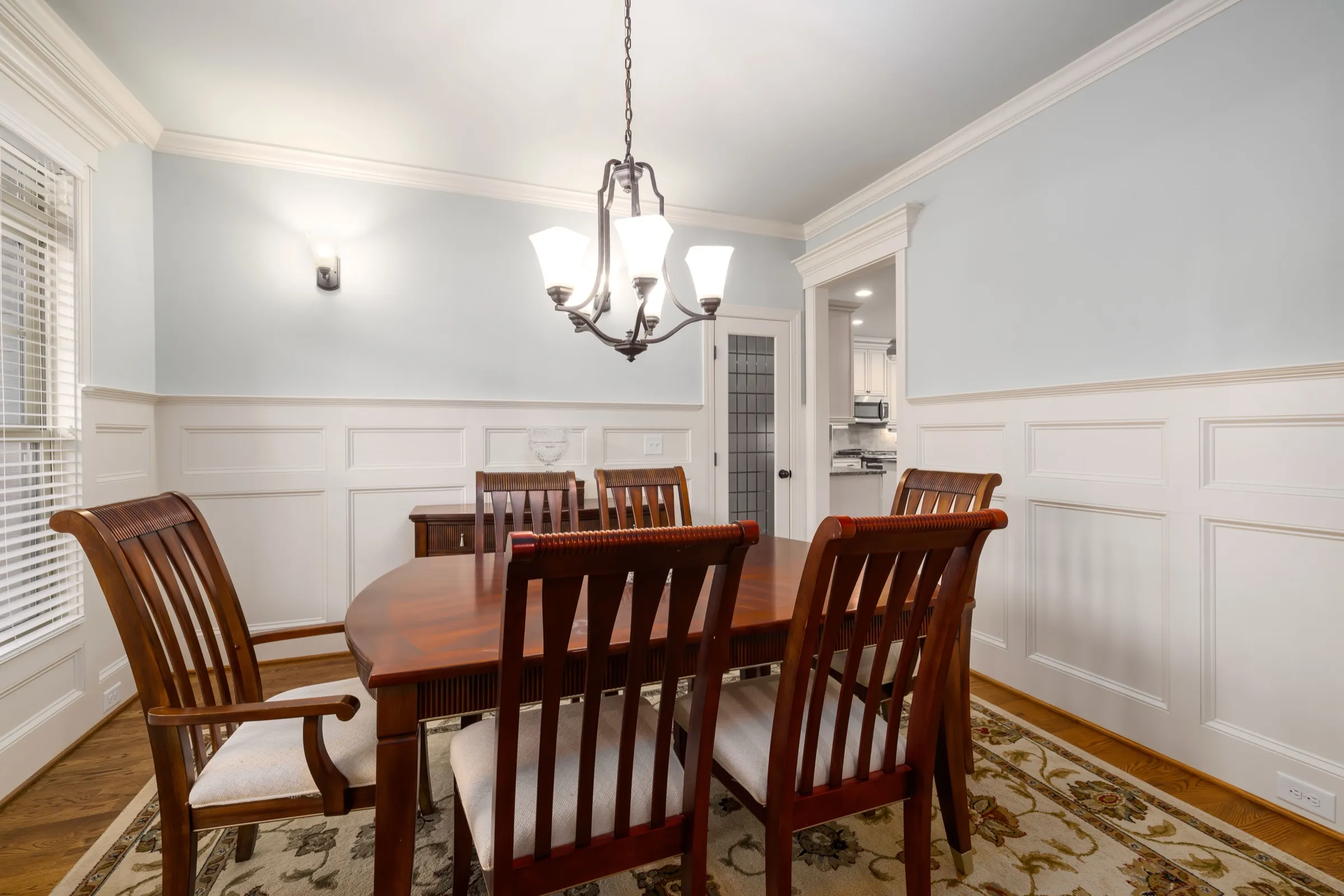 Traditional dining room with flat-panel wainscoting and pale blue walls