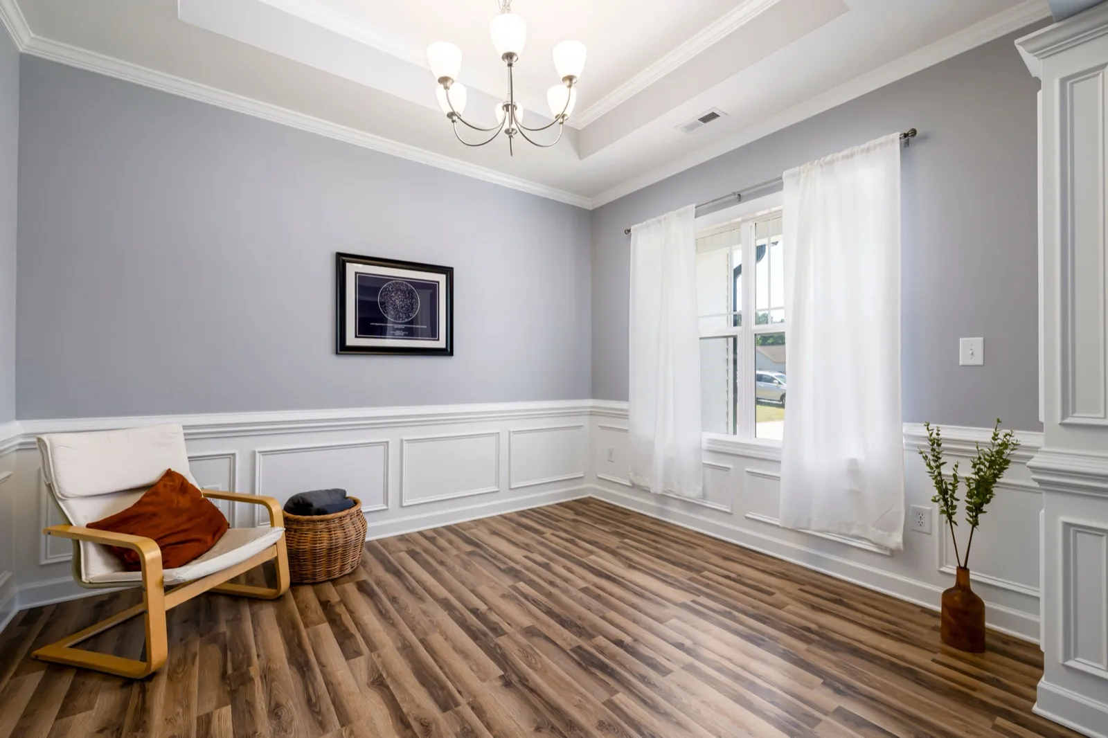 Room with a floor-to-ceiling paneled pilaster wrapping the corner, alongside standard-height wainscoting on the rest of the walls